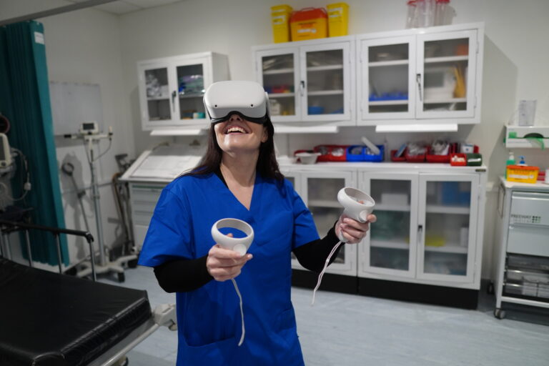 Woman in scrubs in VR headset